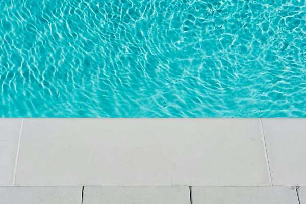 How do you detect and repair leaks in a UK home swimming pool?
